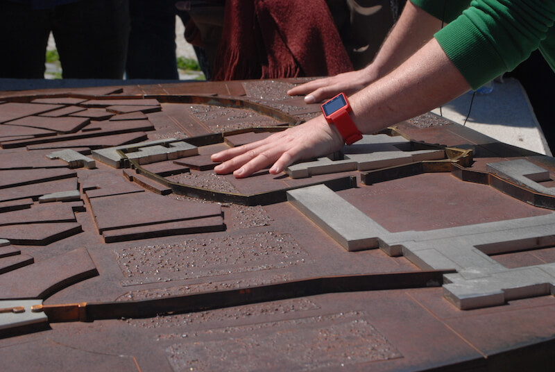Travel guide looking at a map